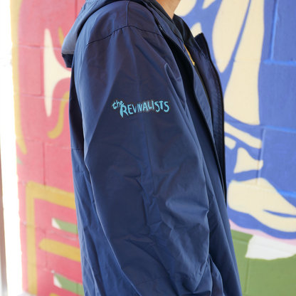 Navy blue jacket with ’Revivalists’ embroidered on the sleeve in teal lettering.