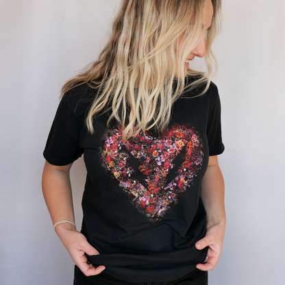 Black t-shirt with floral heart graphic.