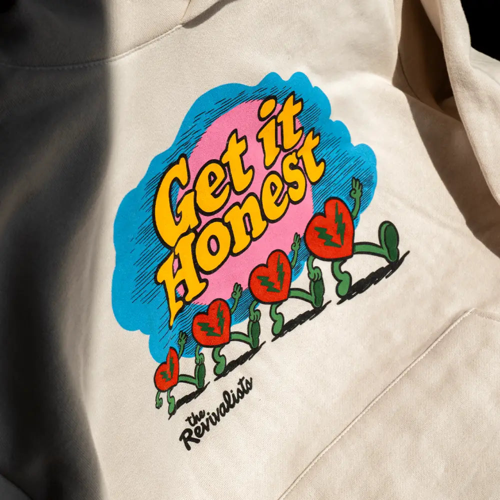 Cream-colored good company hoodie with vibrant get it honest graphic and red hearts on front for casual wear