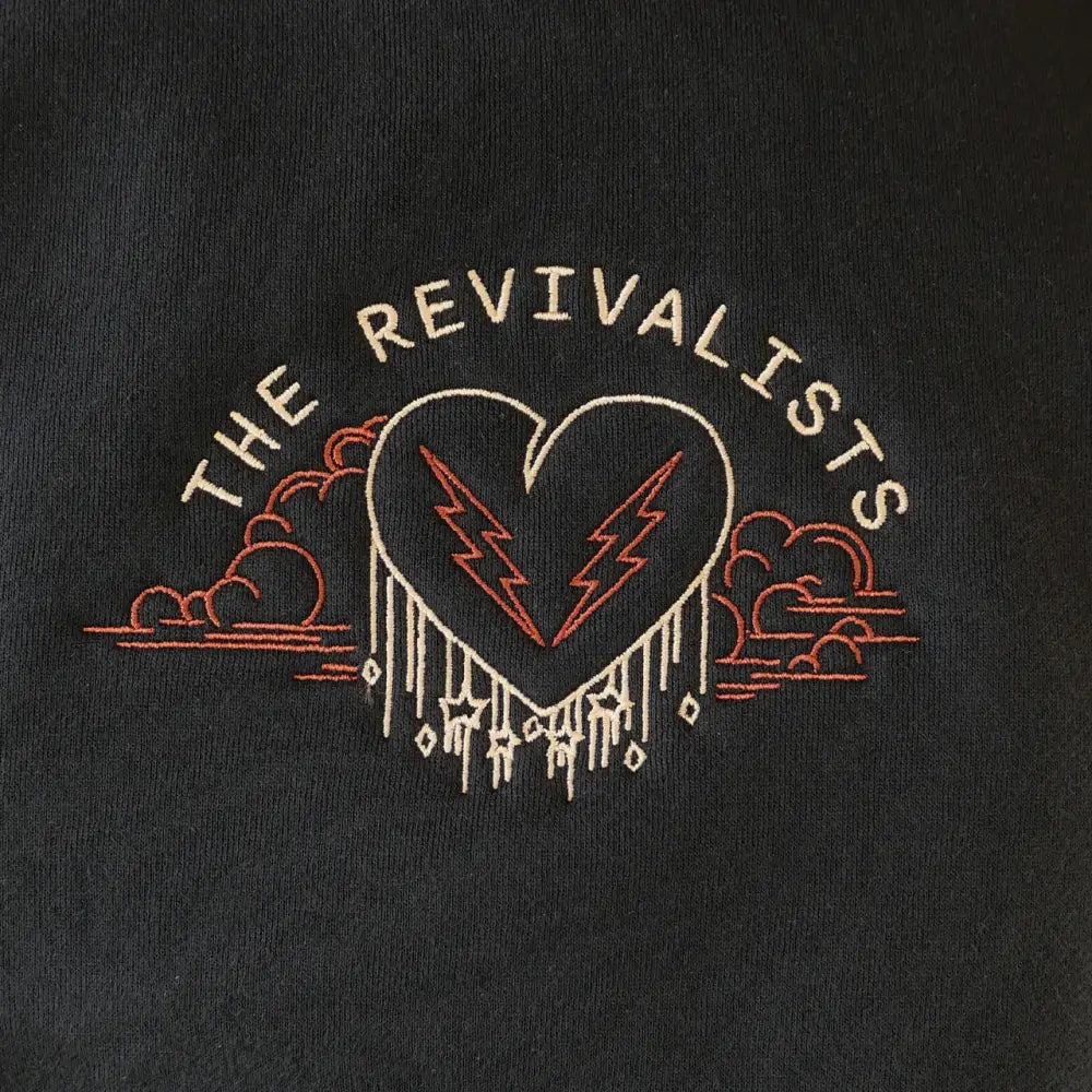 Embroidered logo featuring a heart with lightning bolts and the text ’THE REVIVALISTS’ above.