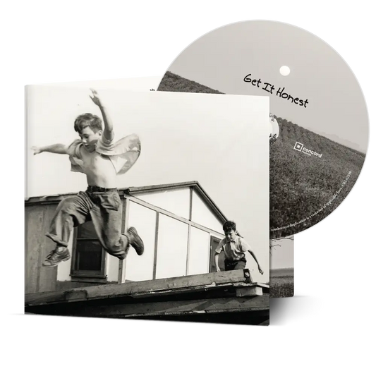 Black-and-white photo of two boys with one mid-jump on wooden structure for bad bad get it honest cd pre-order