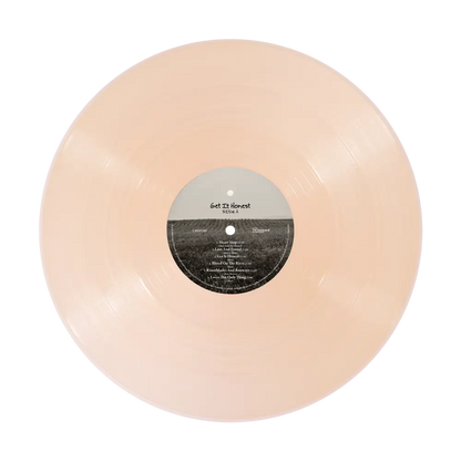 A translucent peach-colored honest vinyl record in limited edition crystal rose color with get it honest tracklist label