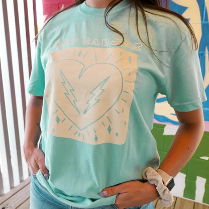 Mint green t-shirt with a light-colored heart and lightning bolt design on the front.