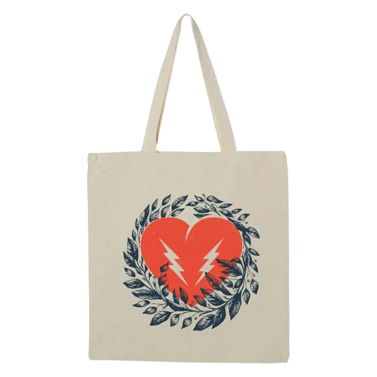 Canvas tote bag with a heart and lightning bolt design surrounded by a wreath of leaves.