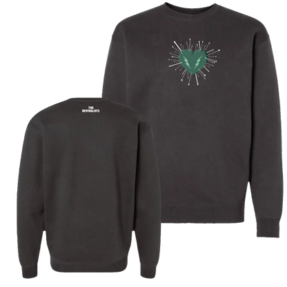 Dark gray crewneck sweatshirt featuring a green heart with lightning bolt and white radiating lines on the front, branded ’the revivalists’ at the back.