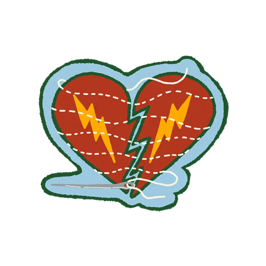 A sewn heart sticker featuring a stylized red heart with green outline split by jagged bolts and white stitched lines