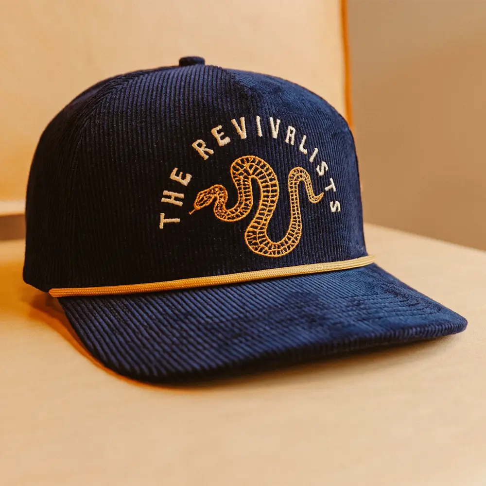 Navy blue corduroy snake hat with gold embroidered snake and the revivalists text logo
