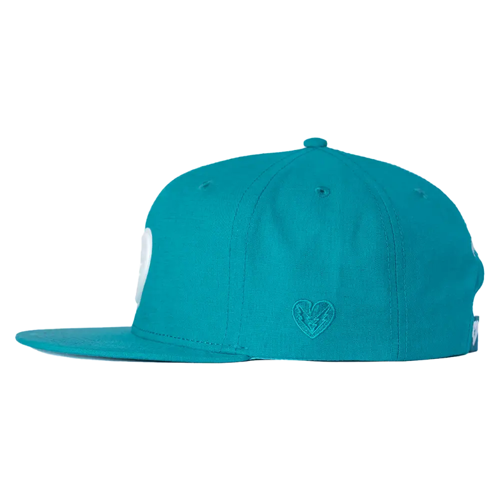 Teal flat-brimmed baseball cap with a small embroidered logo on the side.