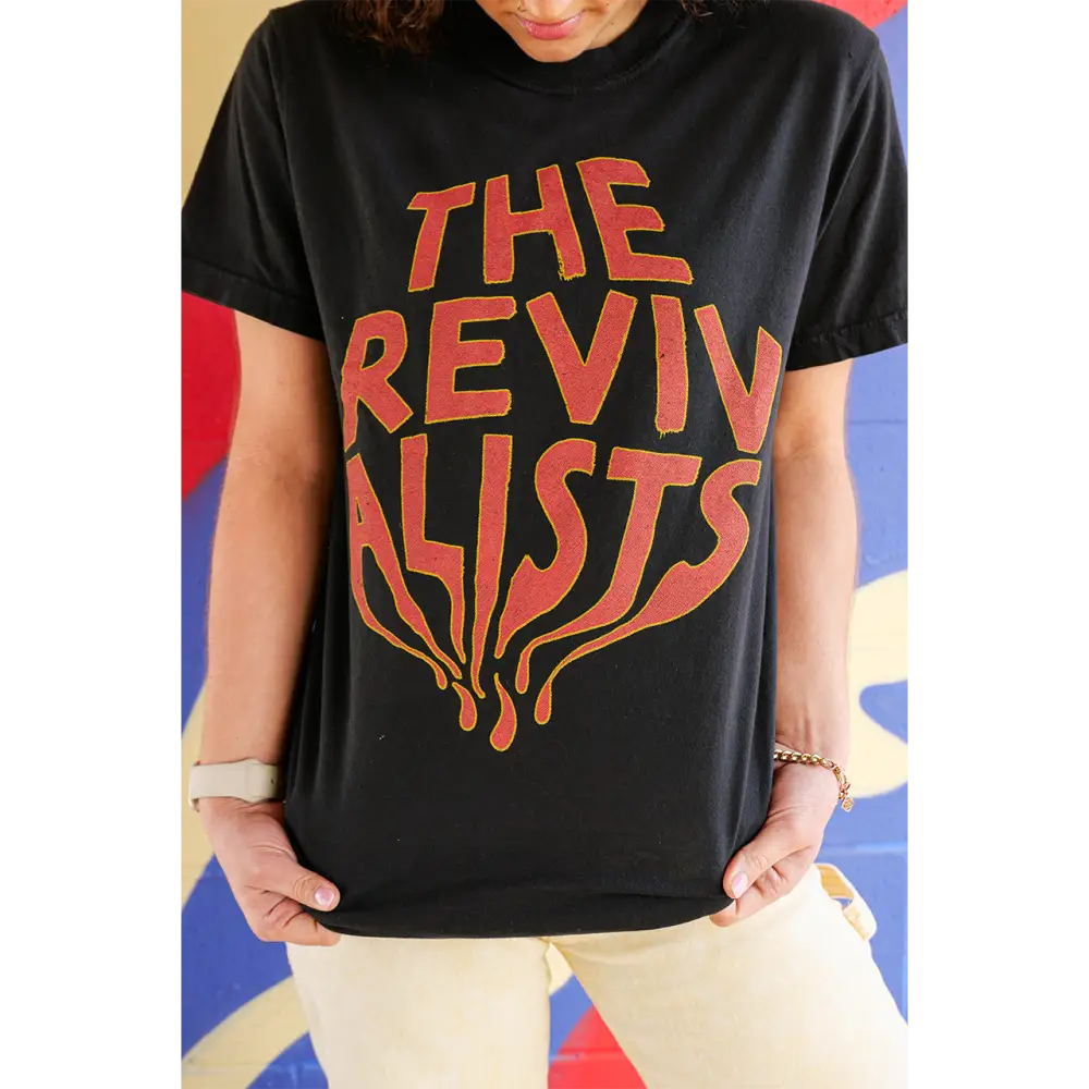 Black t-shirt with ’THE REVIVALISTS’ printed in orange lettering.